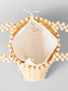 Handmade cream beaded tote bag with a white canvas drawstring lining for beach vacation