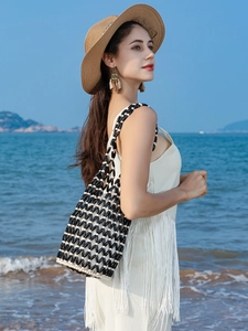 Handmade beaded bucket bag with black and white wavy grid pattern for beach vacations