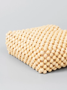 Handmade wooden beaded tote bag in beige for beach travel with woven details