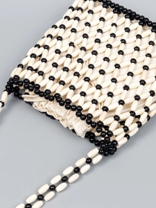 Handmade black and white beaded shoulder bag with canvas drawstring pouch for beach vacations