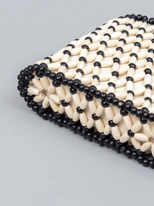 Handmade woven bead shoulder bag with cream and black geometric pattern for beach vacation