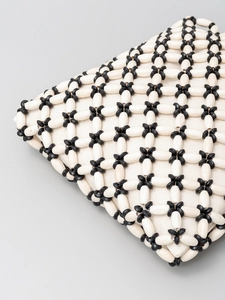 Handmade beaded tote bag with black and white woven pattern for beach vacations