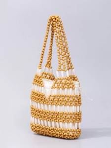 Handmade hollowed wood bead handbag with contrast color weaving and canvas drawstring liner