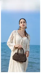 Detail of dark brown handmade wood bead woven bag with natural bohemian style texture
