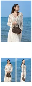 Detailed close-up of dark brown wooden bead woven handbag with round handle at beach