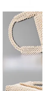 Detail of handcrafted cream wood beads showing the intricate weaving on the handbag strap