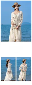 Detail of bohemian woven crossbody bag with fringe tassels and white lace summer dress