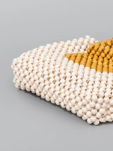 Handcrafted wooden bead handbag featuring cream and mustard yellow woven texture design
