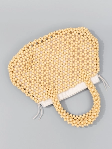 Handmade beaded straw tote bag with beige wooden beads and a canvas drawstring liner