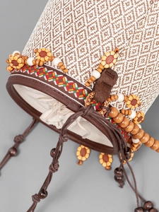 Ethnic straw bucket bag with drawstring closure, geometric weaving and decorative beads