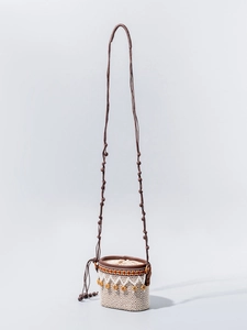 Ethnic woven mini bucket bag with geometric patterns, fringe details, and long strap