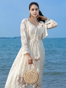 Handmade round wooden bead handbag for beach vacation paired with white crochet lace dress