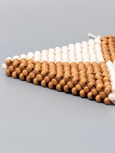 Handmade woven wooden bead bag with geometric brown and cream patterns for beach vacations