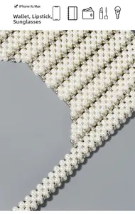 Detail of beaded shoulder bag interior showing capacity for phone, wallet and lipstick