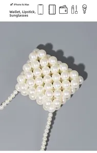 Detail of white pearl woven mini bag showing storage for phone and small essentials