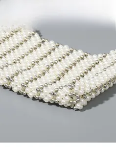 Detail of handcrafted woven bag showing white pearls and silver beads texture