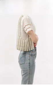 Detailed view of handmade woven pearl shoulder bag with vertical beaded texture and white sheen