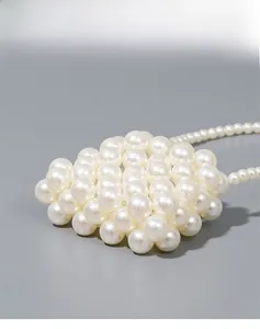 Detailed macro view of handmade woven creamy white pearls with a soft glossy texture