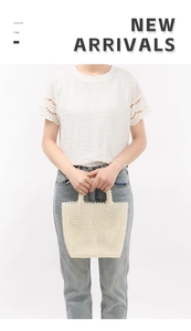 Detail shot of a handmade white pearl woven handbag styled with white lace and denim