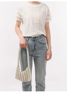 Detail view of handmade white beaded pearl shoulder bag with elegant metallic accents