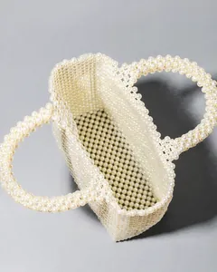 Detailed top view of handmade ivory pearl beaded tote bag showing spacious interior space