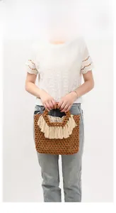 Dettaglio di una borsa in perline di legno intrecciata a mano con eleganti frange beige