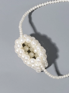 Elegant cream white faux pearl woven mini crossbody bag for women on grey surface