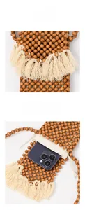 Detail of handmade beaded phone bag with natural wood beads and ivory fringe tassels