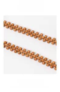 Detail of handcrafted wooden bead shoulder strap with double-row woven texture