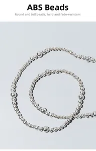 Detailed macro view of high-quality silver ABS imitation pearls on an elegant woven bag