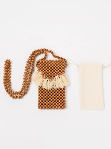 Handmade wooden bead crossbody bag with ivory cotton tassels and a matching drawstring pouch