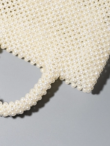 Handmade pearl beaded tote bag with glossy round beads for beach vacations and elegant style