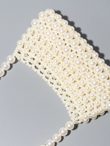 Handcrafted white pearl beaded shoulder bag for beach vacations with intricate hollow weave