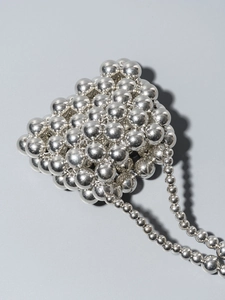 Handmade silver beaded crossbody bag with metallic polished finish for vacation and parties