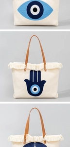 Detail of towel embroidery Evil Eye and Hamsa Hand on bohemian canvas tote bag