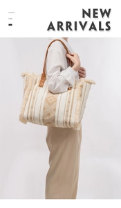 Detail of bohemian canvas tote featuring geometric embroidery and brown tassel trim