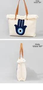 Detail view of embroidered hamsa hand tote bag showing 30 and 90 degree side angles