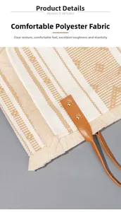 Close-up of woven canvas tote bag showing polyester texture, fringe details and leather rivets