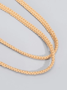 Detailed close-up of macrame woven cotton rope strap on a summer beach bucket bag