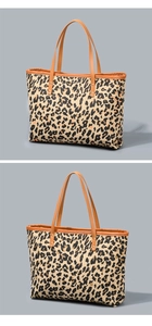 Detailed macro view showing leopard print canvas and leather handle with metal rivets