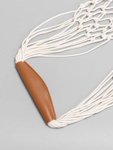 Beige cotton woven beach bag with premium brown leather handle and fine hand-stitching