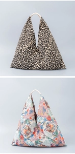 Detailed comparison of leopard print and tiger floral patterns on canvas triangle tote bags