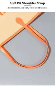 Dettaglio dei manici in morbida pelle PU arancione con cuciture resistenti sulla borsa tote