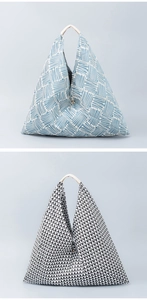 Detail view of woven fabric tote bags with geometric patterns and leather handles