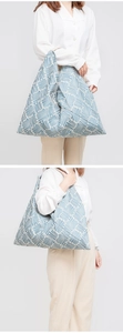 Blue geometric triangular canvas shoulder bag with white stripes and spacious interior