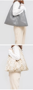 Detail of high-capacity tote bags featuring geometric triangle and checkered weave textures