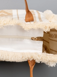 Large bohemian canvas tote bag with fringe trim and brown woven patterns for beach vacation