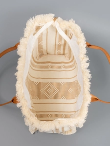 Canvas tassel tote bag with brown geometric patterns and leather handles for beach vacation