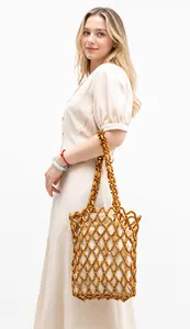 Detail of a handmade wooden bead woven bag with a secure cream-colored fabric inner lining