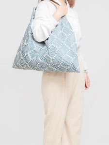 Blue geometric pattern woven canvas shoulder bag shown on model for daily commuting